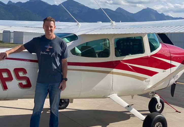 mike rossi and his plane with montana mountains